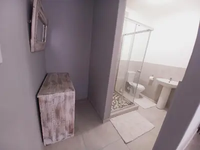 a bathroom with a shower and a toilet and a sink at Lime Court Three in Pretoria
