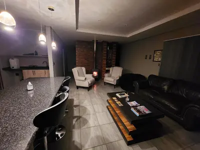 a living room with a couch and a table at Lloyds - 3 in Ermelo