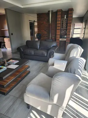 a living room with two couches and a table at Lloyds - 3 in Ermelo