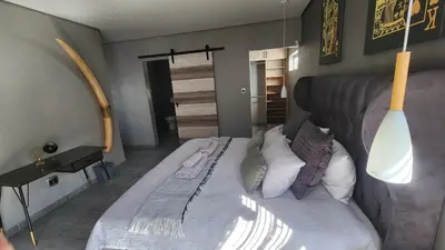 a bedroom with a large bed with pillows at Lloyds - 3 in Ermelo