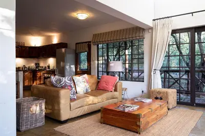 a living room with a couch and a coffee table at Jabulani Bushhouse - Marlothpark in Marloth Park