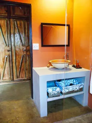 a bathroom with a sink and a bowl on a counter at Jabulani Bushhouse - Marlothpark in Marloth Park