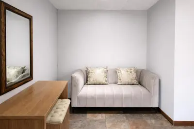 a living room with a couch and a mirror at Magalies Mountain Lodge and Spa in Hartbeespoort