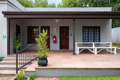 a small house with a bench on a patio at Magalies Mountain Lodge and Spa in Hartbeespoort