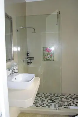 a bathroom with a sink and a shower at Tengo guest house in Phalaborwa