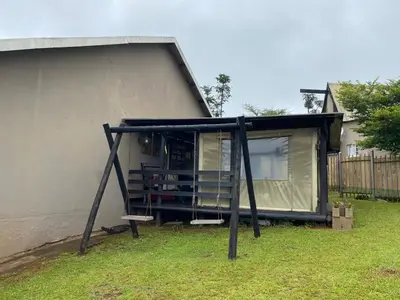 a tiny house with a porch and a bench at La Prima Casa in Graskop