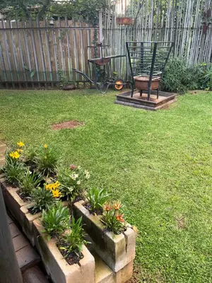 a garden with a bench and flowers in a yard at La Prima Casa in Graskop