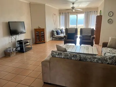 a living room with a couch and a tv at La Prima Casa in Graskop