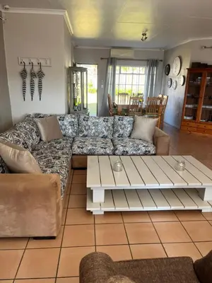 a living room with a couch and a coffee table at La Prima Casa in Graskop
