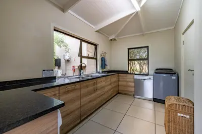 a large kitchen with a sink and a dishwasher at Wildheart Safari - MAIN in Hoedspruit