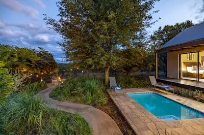 a swimming pool in a yard with a house at Wildheart Safari - MAIN in Hoedspruit