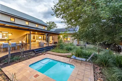 a backyard with a swimming pool and a house at Wildheart Safari - MAIN in Hoedspruit
