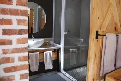 a bathroom with a sink and a mirror at The Stables At Critchley in Dullstroom