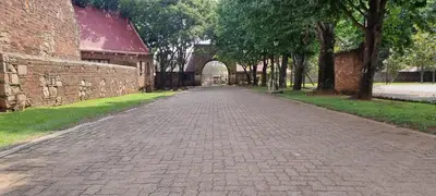 an empty brick road with an archway in a park at DullVino Cottage no 15 at Critchley in Dullstroom