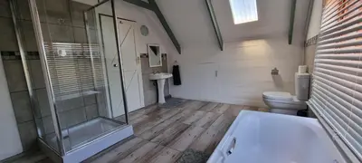 a bathroom with a glass shower and a toilet at DullVino Cottage no 15 at Critchley in Dullstroom