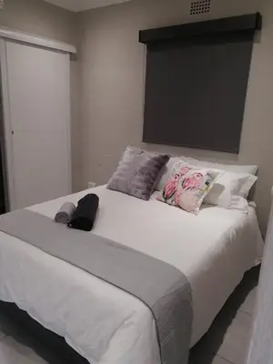 a bedroom with a large white bed with pillows at 394OnEmus in Pretoria