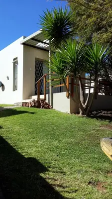 a house with two palm trees in the yard at 394OnEmus in Pretoria