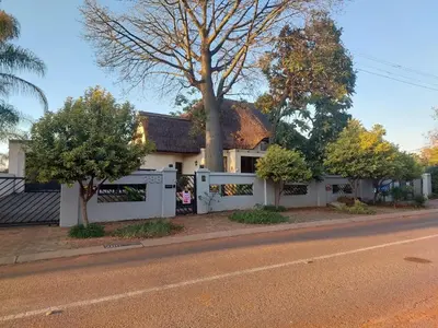 a white house on the side of a street at Garrett B&B in Pretoria