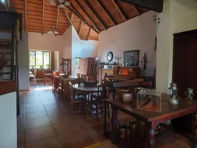 a kitchen and dining room with tables and chairs at Garrett B&B in Pretoria