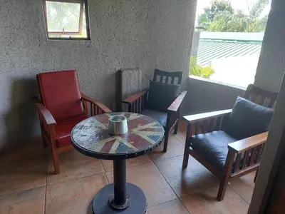 a table and chairs in a room with a table and chairs at Garrett B&B in Pretoria
