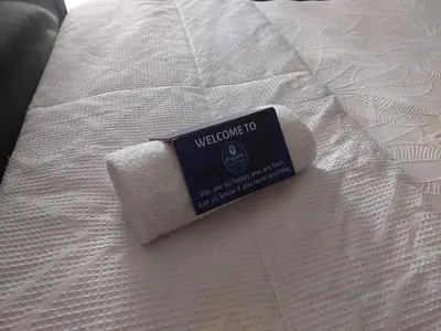 a piece of paper towels sitting on top of a bed at Garrett B&B in Pretoria