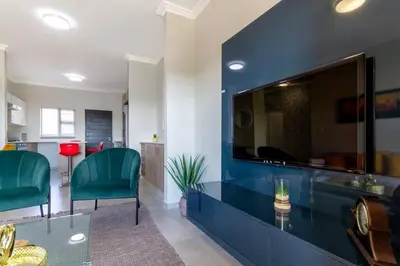a living room with a large blue wall at Alimama Spaces: The Thando's Kyalami Woods in Midrand