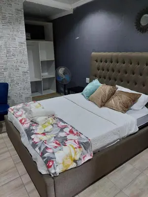 a bed with a blanket on it in a bedroom at Nsuku Bed and Breakfast in Thulamahashi