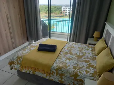 a bedroom with a bed with a blue towel on it at Breathtaking Lagoon View Apartment @ The Blyde1531 in Pretoria