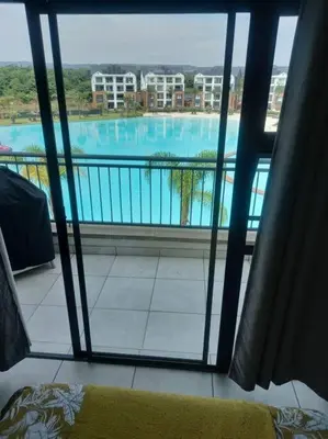 a view of a swimming pool from a window at Breathtaking Lagoon View Apartment @ The Blyde1531 in Pretoria