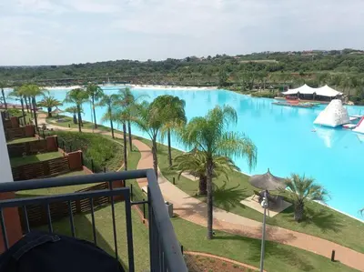 a view of a large pool of water with palm trees at Breathtaking Lagoon View Apartment @ The Blyde1531 in Pretoria