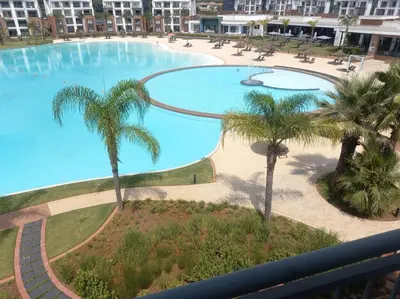 a view of a large swimming pool with palm trees at Breathtaking Lagoon View Apartment @ The Blyde1531 in Pretoria