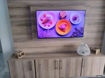 a flat screen tv on top of a wooden entertainment center at Breathtaking Lagoon View Apartment @ The Blyde1531 in Pretoria