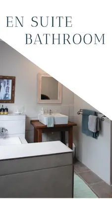 an attic bathroom with a sink and a mirror at East of East Guest Cottage in Avondzon
