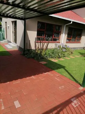 a brick walkway in front of a house at Garden and Park Leisure on Tugela in Benoni