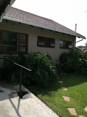 a house with a cross in front of it at Garden and Park Leisure on Tugela in Benoni