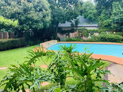 a swimming pool in a yard with some plants at Garden and Park Leisure on Tugela in Benoni
