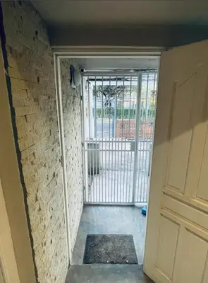 an entrance to a room with a door and a gate at Grace Gardens - Grace in Pretoria