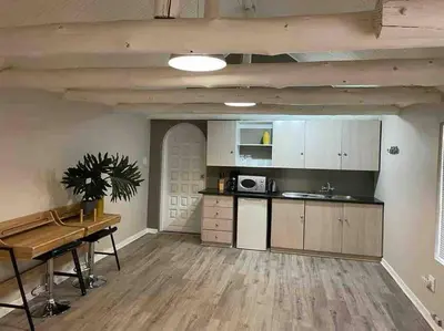 a kitchen with a table and a counter top at Grace Gardens - Grace in Pretoria
