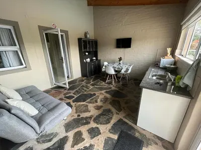 a living room with a couch and a table at Koi Inn in Hartbeespoort