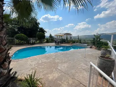 a swimming pool in a yard with a patio at Koi Inn in Hartbeespoort