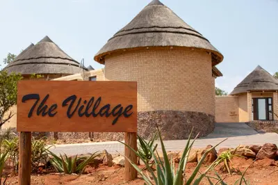 a sign in front of a building with turrets at Lichenry Bush Lodge in Mokopane
