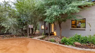 a house with a dirt road in front of it at Wildheart Safari - Zesty Zebra in Hoedspruit