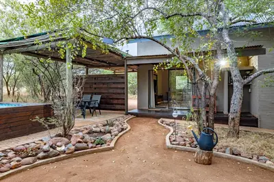 a backyard with a house with a patio at Wildheart Safari - Zesty Zebra in Hoedspruit