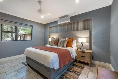 a bedroom with a large bed and a window at Wildheart Safari - Zesty Zebra in Hoedspruit