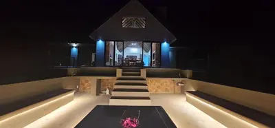a room with a table and some blue lights at Thabanyane Private Lodge Mabalingwe in Bela-Bela