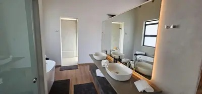 a bathroom with two sinks and a large mirror at Thabanyane Private Lodge Mabalingwe in Bela-Bela