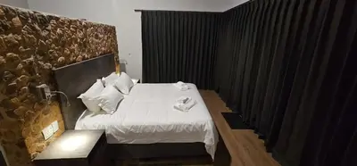 a bedroom with a bed with two towels on it at Thabanyane Private Lodge Mabalingwe in Bela-Bela