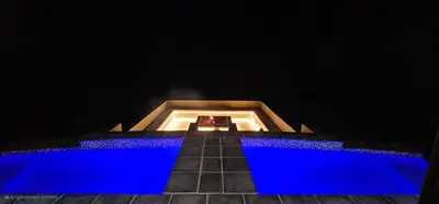 an empty stage with blue lights in a dark room at Thabanyane Private Lodge Mabalingwe in Bela-Bela