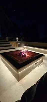 a fire pit in the middle of a building at night at Thabanyane Private Lodge Mabalingwe in Bela-Bela