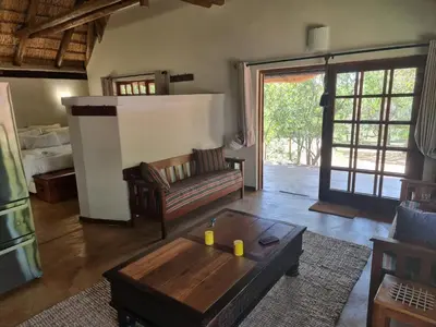 a living room with a couch and a coffee table at Milkwood Cottage Mabalingwe in Bela-Bela